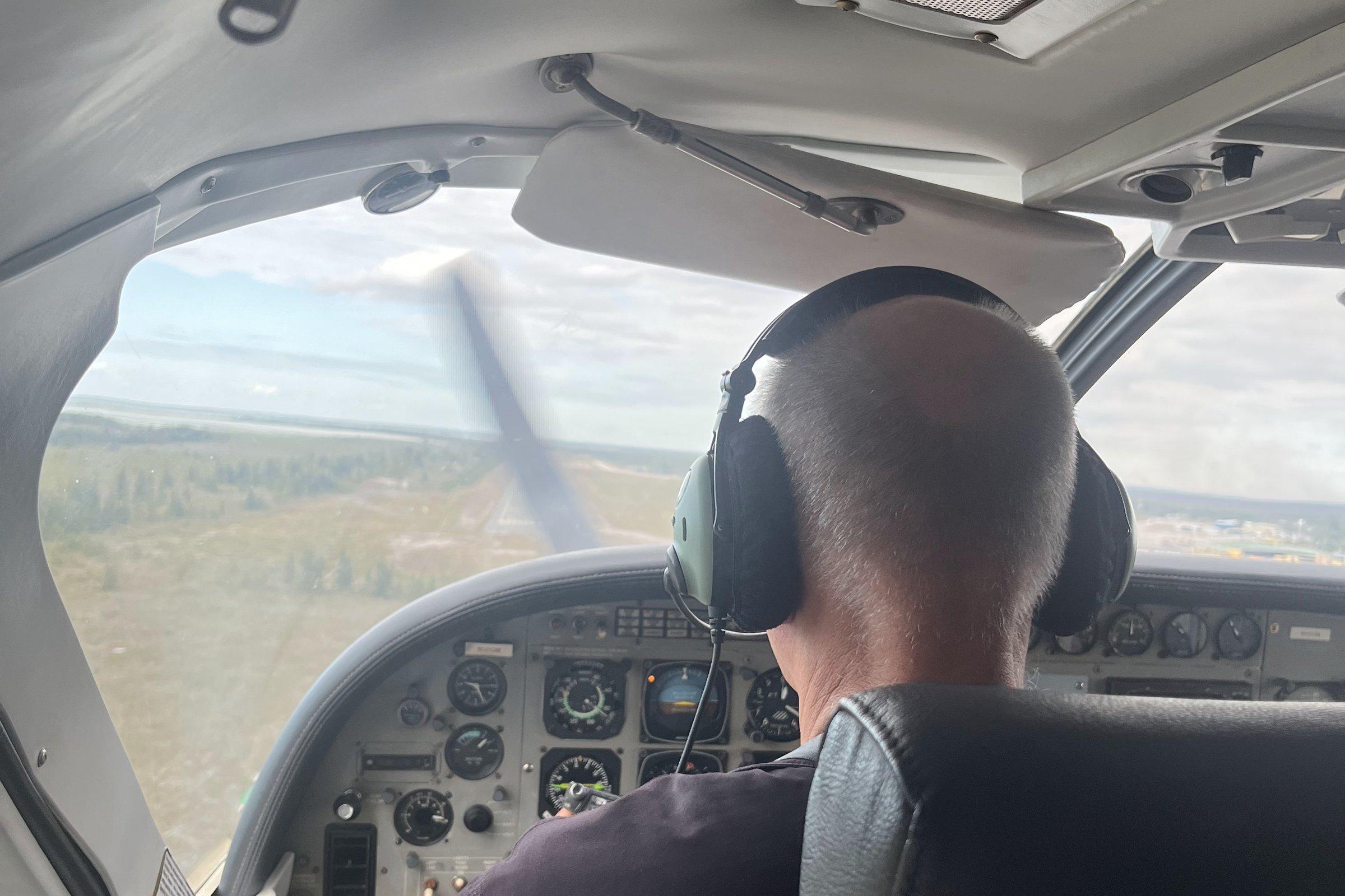 A Buzz Air pilot on approach, seen from the cabin
