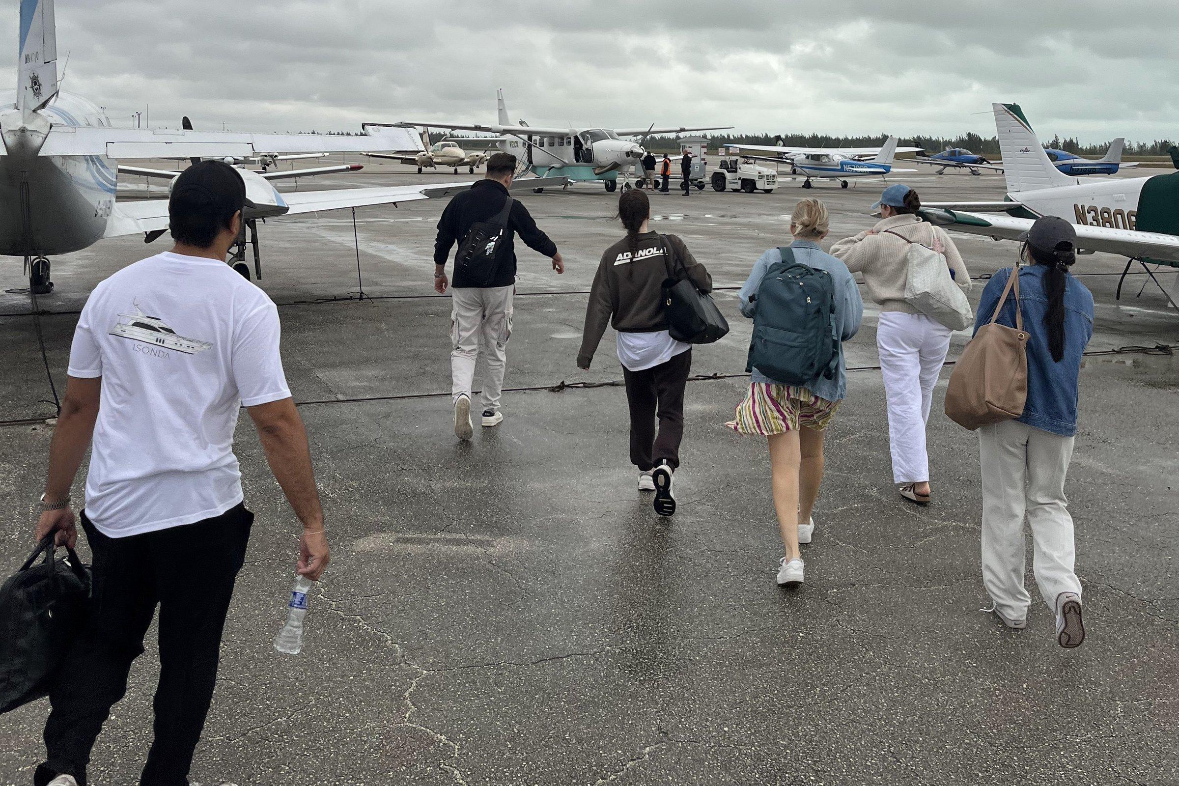 Buzz Air passengers walking out to the aircraft on the ramp